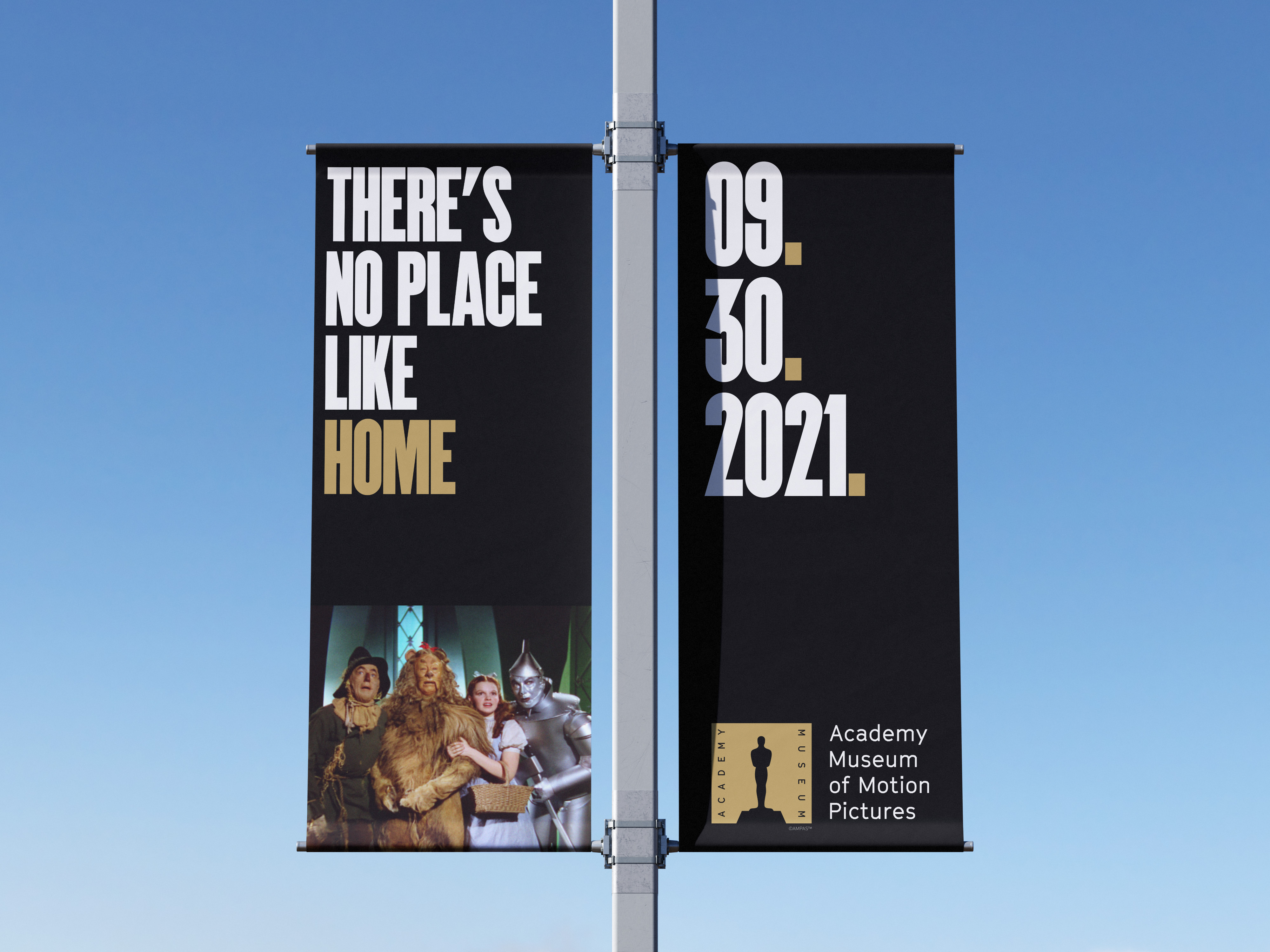 Academy Museum street banners with There's No Place Like Home, an opening date, and characters from The Wizard of Oz.